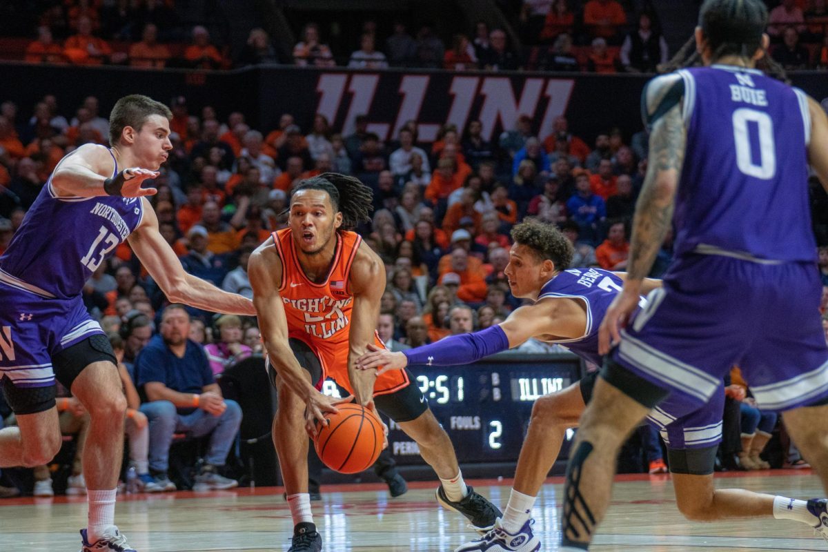 Junior guard Ty Rodgers holds onto the ball as Northwestern makes an effort to steal it away on on Jan. 2.