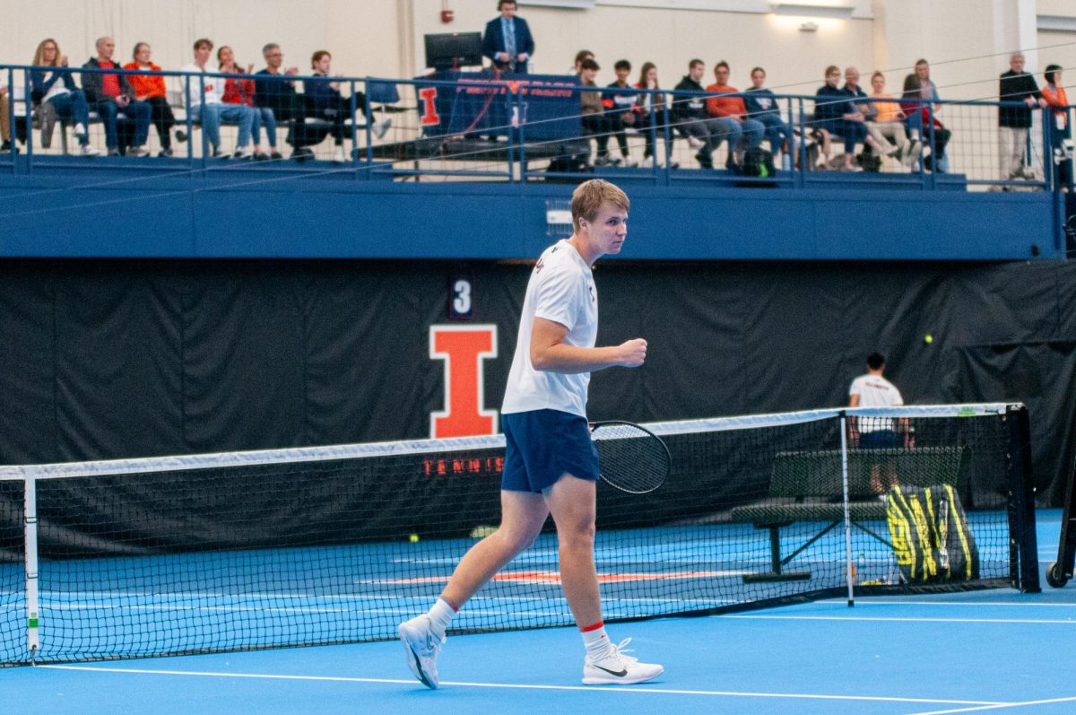 Senior Karlis Ozolins pumps his fist after winning a point against Duke in a match on Feb. 2.