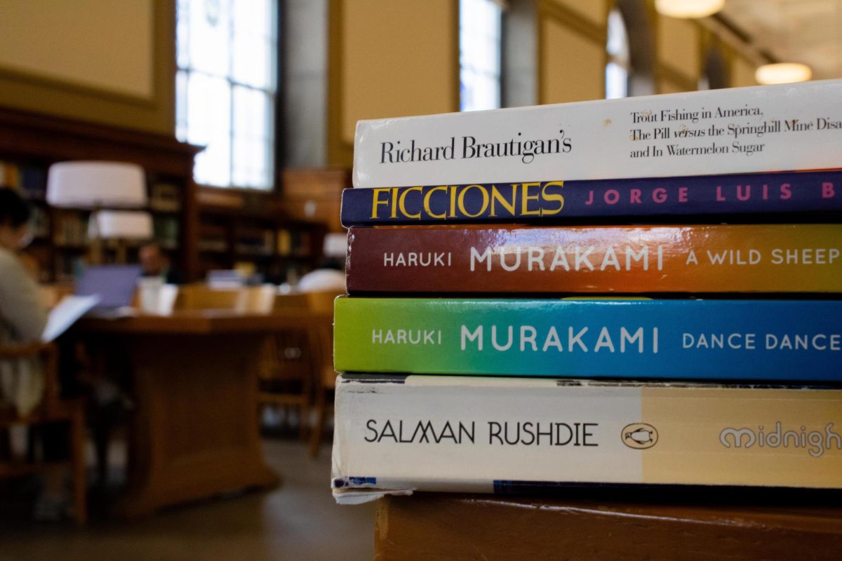 Five magical realism books sit on a table in the Main Library.
