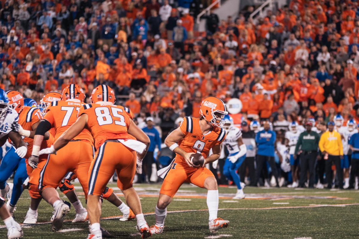 Illinois Quarterback Luke Altmyer shovels a pass off to a running back during Illinois' big win over Kansas on Saturday.