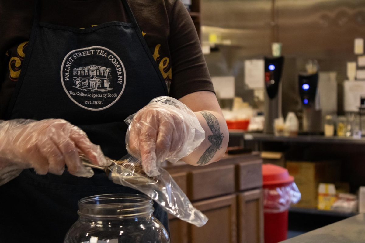 An employee bags loose-leaf tea inside Walnut Street Tea Company's location at 2510 Village Green Place in Champaign. The store sells tea, coffee and mugs, and it serves drinks in the café and drive-thru.