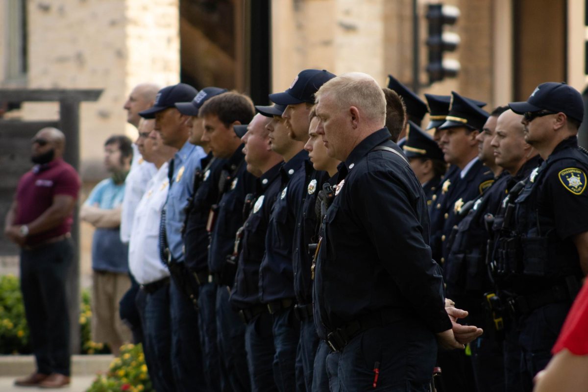 Champaign police officers pay their respects to lives lost by first responders on 9/11 at the Champaign Fire Department's annual 9/11 memorial at West Side Park in Champaign, Ill. on Sept. 11.