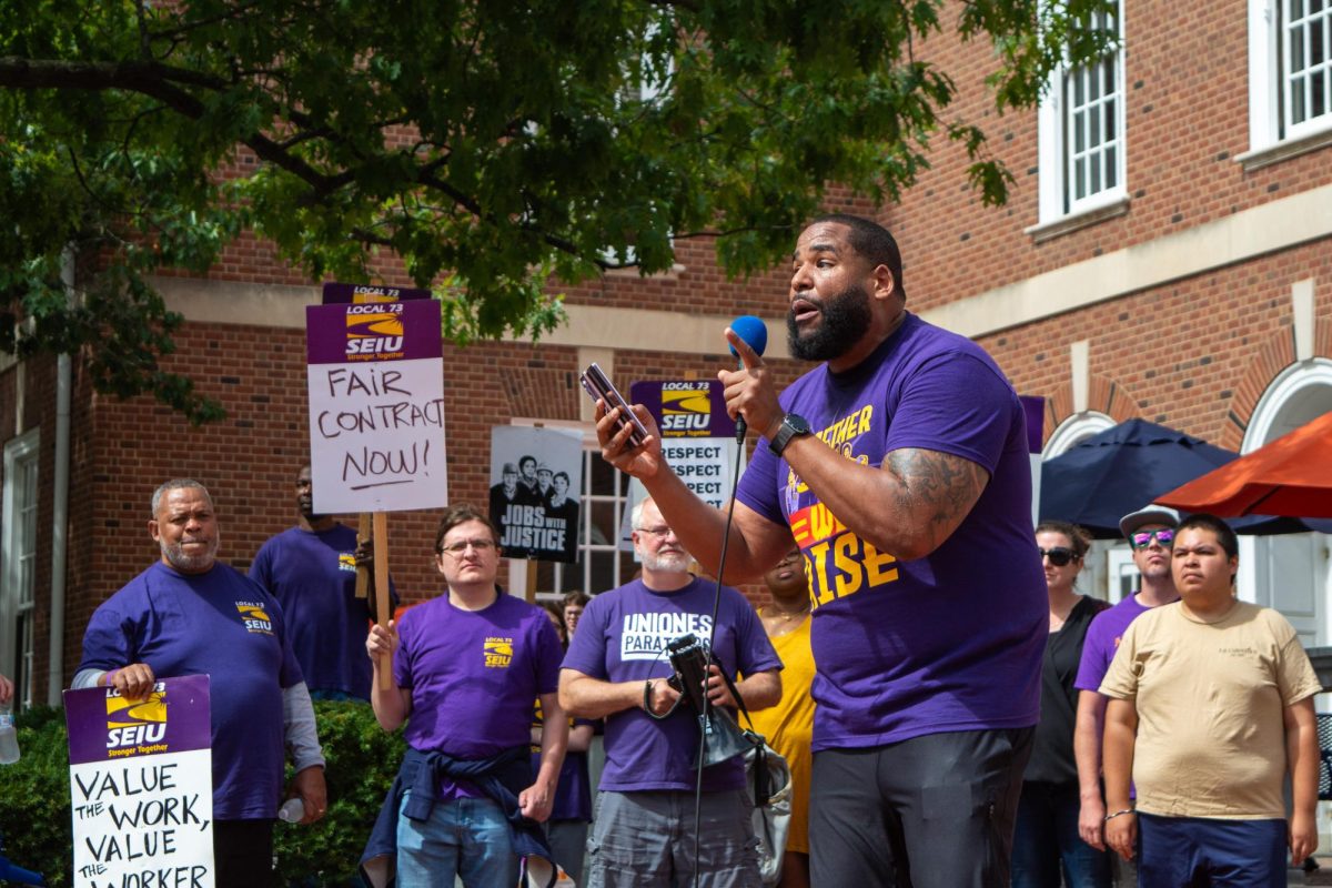 Augustus Wood, Assistant Professor in the School of Labor & Employment Relations, speaks about workers' rights to members of the Service Employees International Union (SEIU) on Friday afternoon. SEIU represents building workers across campus and voted to strike last week.