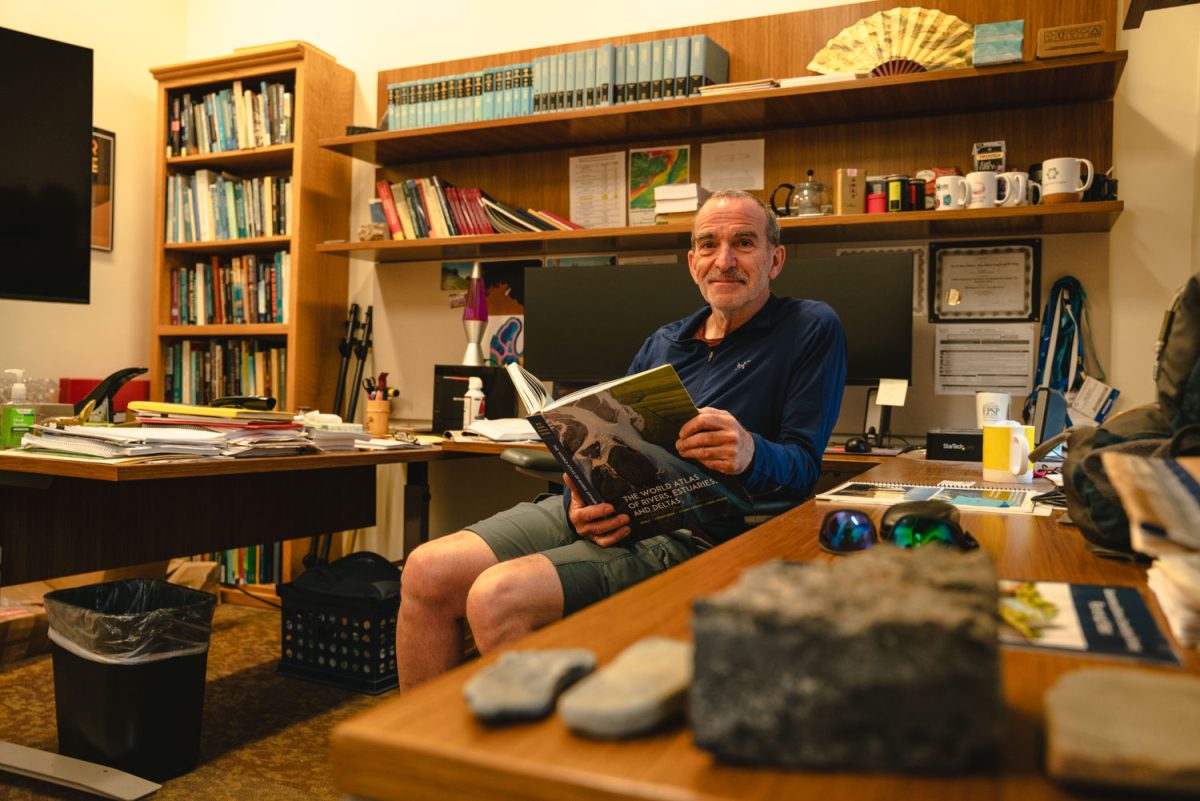 Professor Jim Best in his office located at the Natural History Building in Urbana during a rainy Sept. 23, 2024  with his recently released book "The World Atlas of Rivers, Estuaries, and Deltas."