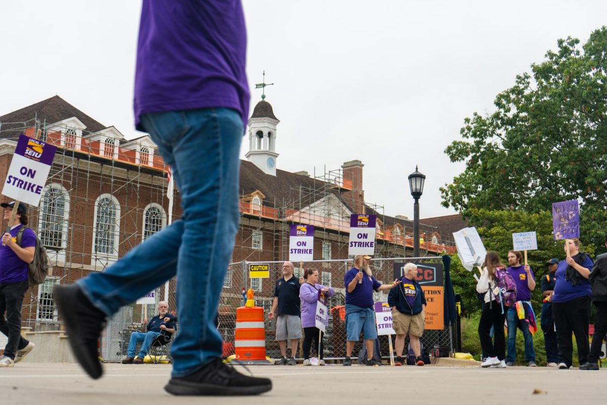 University SEIU workers sing chants and march in circles on strike. The strike began Sept. 23 to demand better wages and other changes.