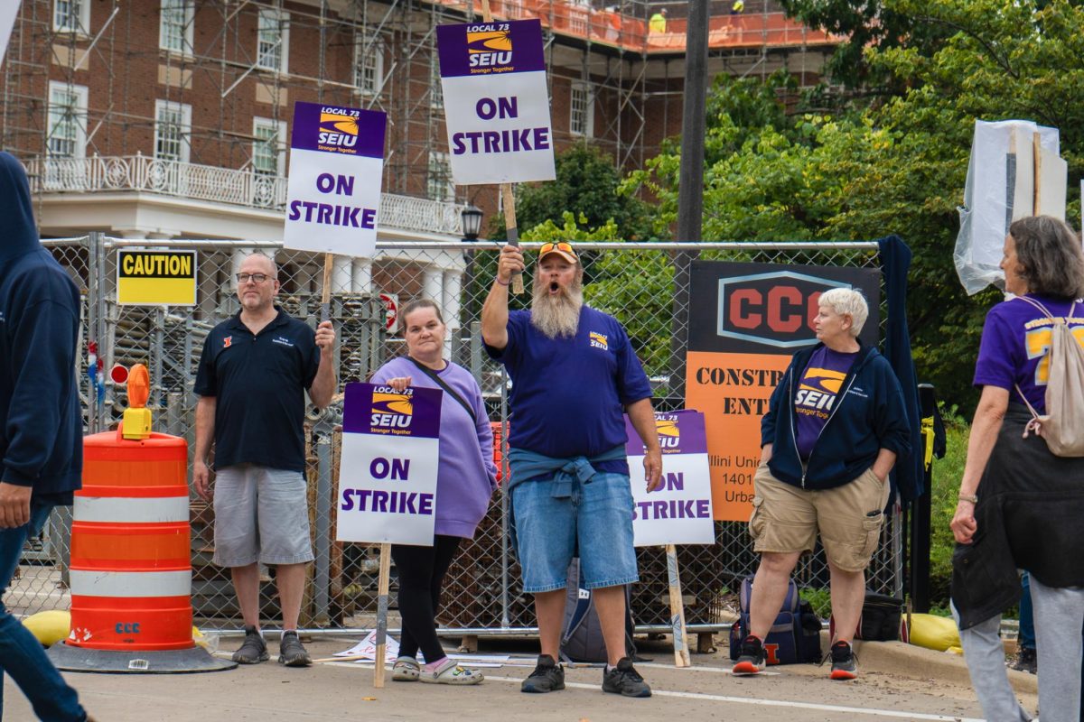 University SEIU workers sing chants and march in circles on strike. The strike began Sept. 23 to demand better wages and other changes.