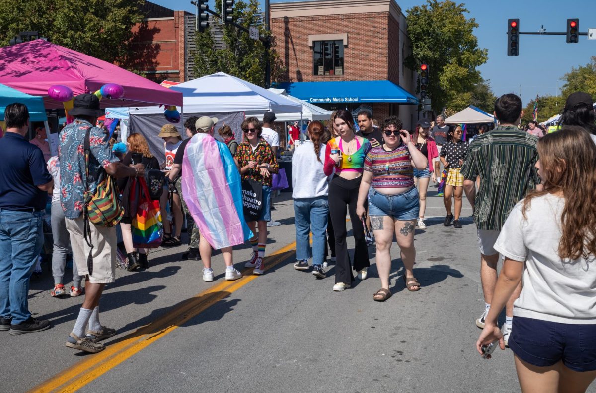 Attendees of Pride Fest browse at the corner of Main and Race in downtown Urbana.
