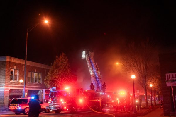 A fire truck sits with its ladder extended on 2nd street during a fire in an abandoned building in Champaign in the spring.