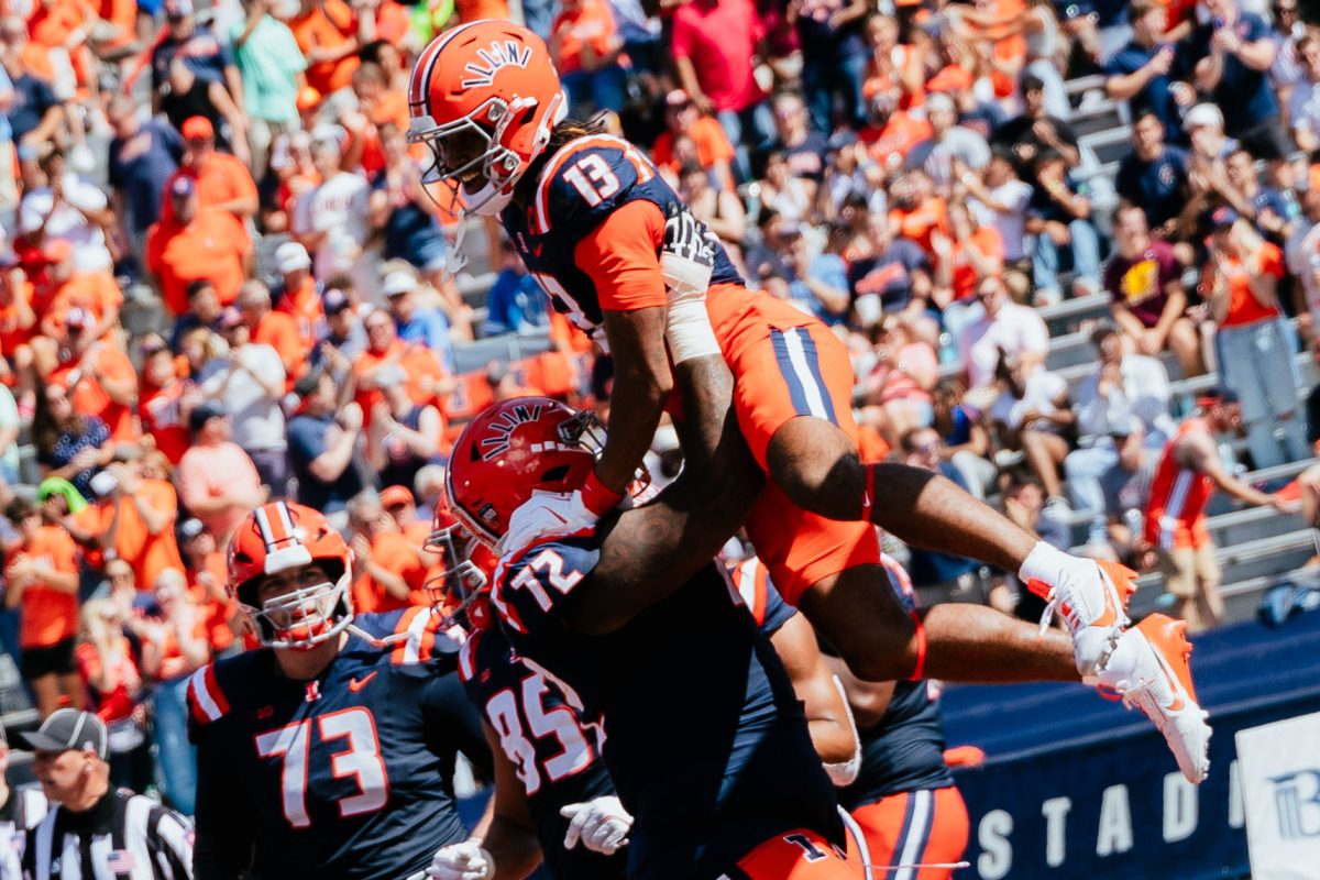 After a touchdown against Central Michigan from senior wide receiver Pat Bryant, senior offensive lineman Zy Crisler lifts Bryant to the air in celebration on Saturday. 
The Illini defeated the Chippewas 30-9 during homecoming at Memorial Stadium.