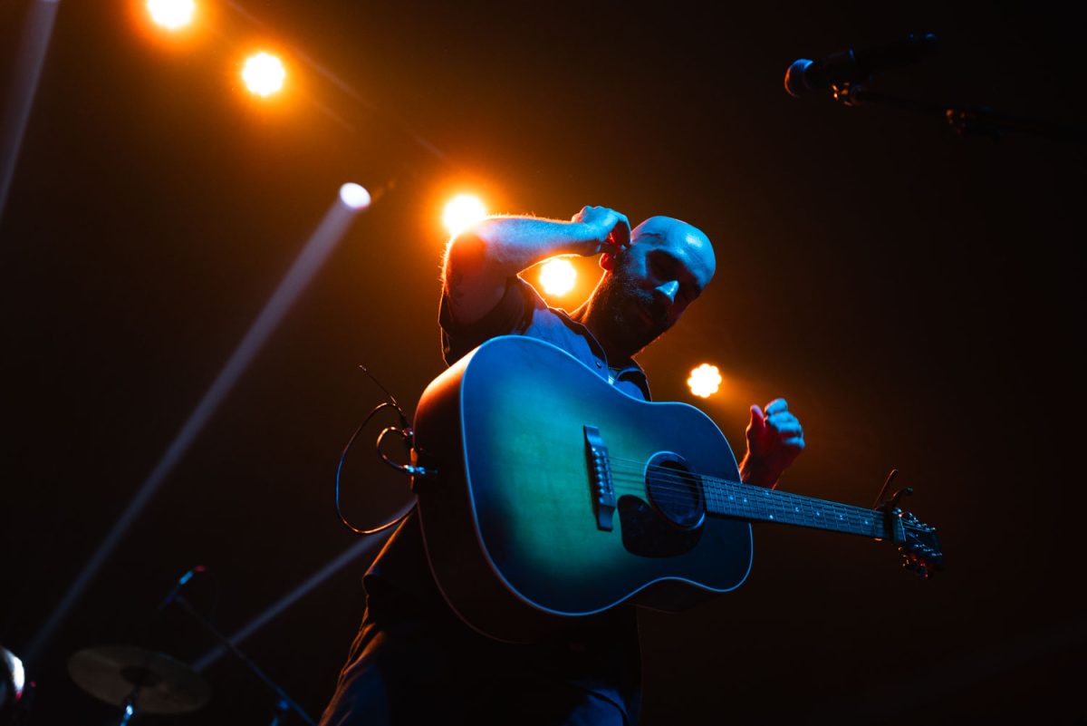 X Ambassadors lead singer Sam Harris adjusts his ear piece as he approaches the mic at Canopy Club during Pygmalion on Friday.