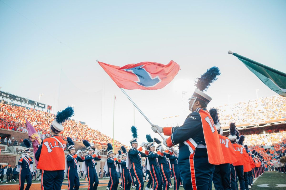 Members of the Marching Illini hold flags of all the teams in the Big 10 before the Illinois football game on Sept. 7.