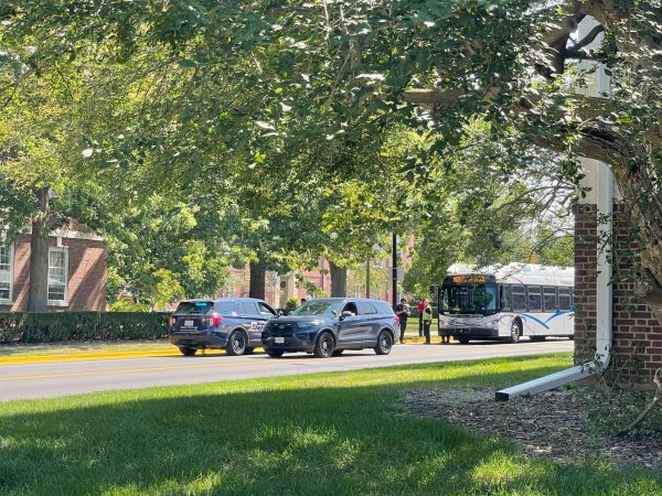 A couple of UIPD officers linger with their vehicles after the accident involving a MTD bus and a student on Tuesday.