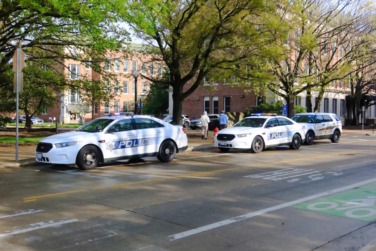 Champaign Police cars stand by on Green Street during the Pro-Palestine Encampment on April 26.