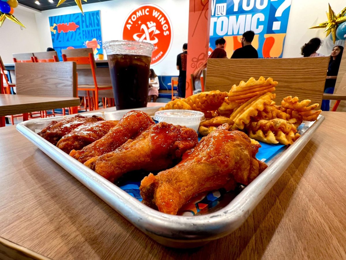 A meal from Atomic Wings including five hot buffalo wings, seasoned fries and a fountain drink.