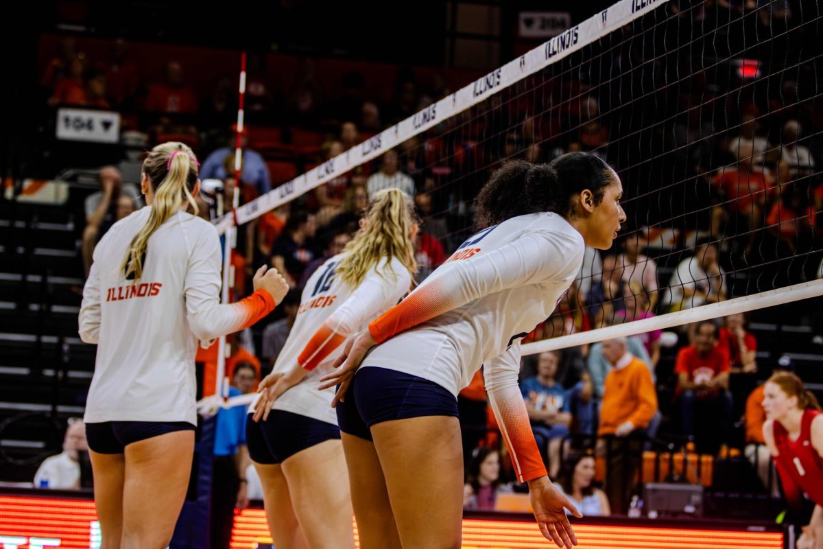 Illinois volleyball players signal to their teammates in a match against Illinois State University on Sept. 3.