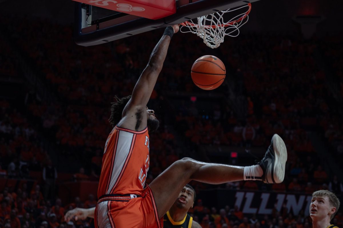 Graduate student Quincy Guerrier slams the ball through the basket during the Illinois v Iowa game at the State Farm Center on S First St., Feburary 24, 2024