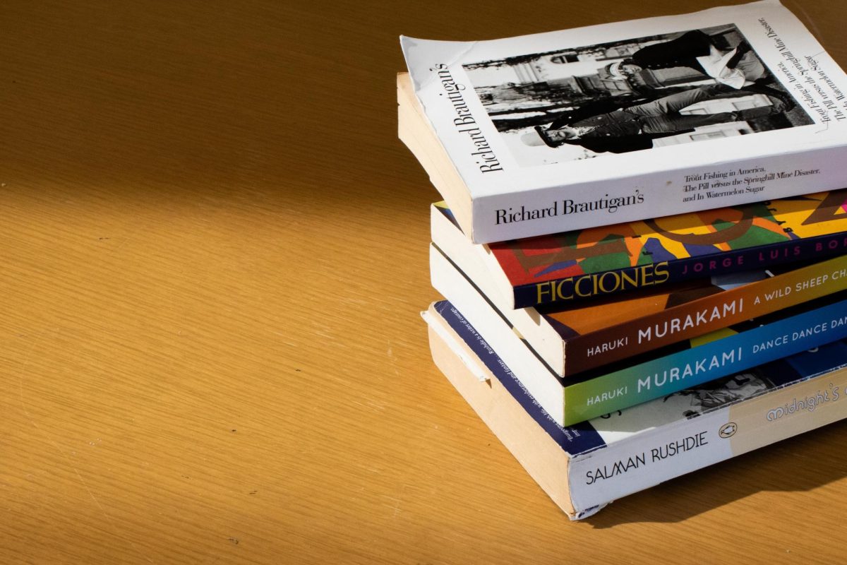 A stack of five magical realism books sit on a table in the Main Library on Sept. 6.