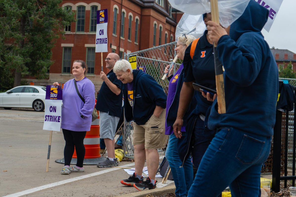 University SEIU workers sing chants and march in circles on strike. The strike began Sept. 23 to demand better wages and other changes.