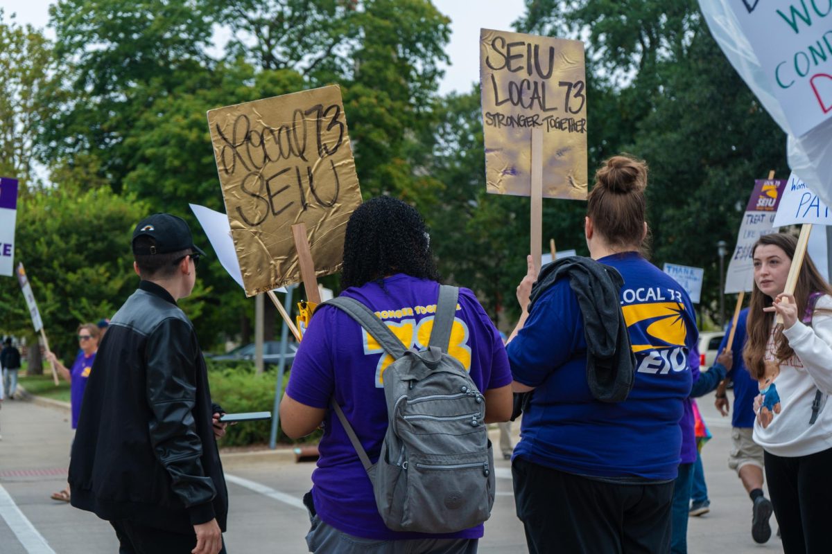 University SEIU workers sing chants and march in circles on strike. The strike began Sept. 23 to demand better wages and other changes.