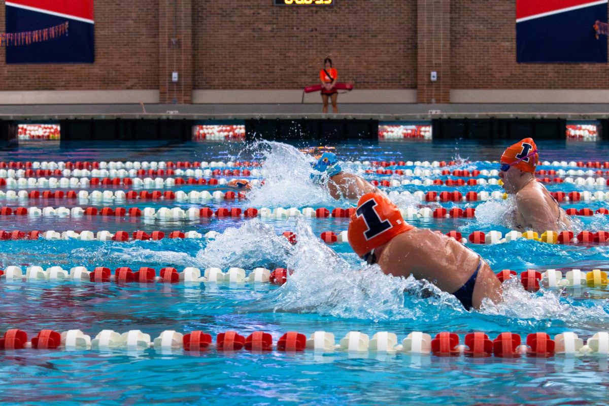 Senior Jane Umhofer and sophomore Gwen Bakker swim through their 200 meter breaststroke heat at the Illinois versus Kansas meet on Thursday, Oct. 10. 