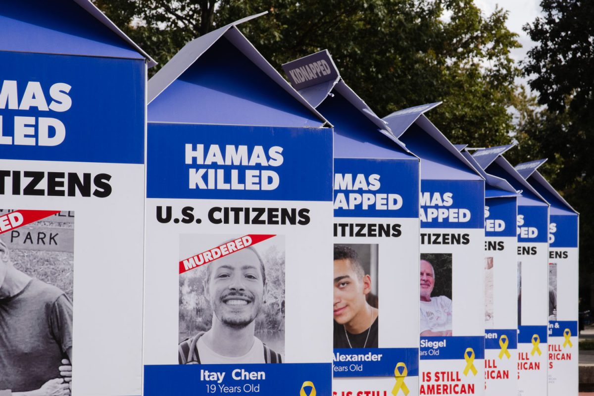 Illini Chabad holds a demonstration at Anniversary Plaza on Monday including structures such as milk cartons depicting photos of American hostages captured by Hamas and several large art installations.