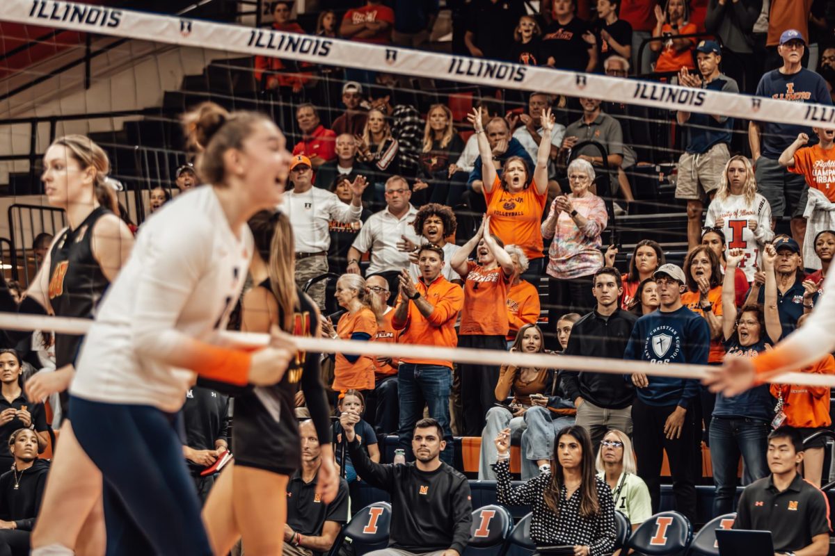 Illinois fans erupt in celebration as the team secures a crucial point to close out the first set against Maryland on Oct. 20.