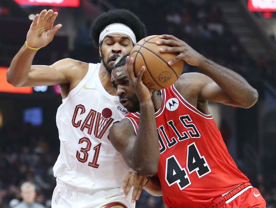 Chicago Bulls forward Patrick Williams drives to the basket guarded by Cleveland Cavaliers center Jarrett Allen in the first half of their preseason game at Rocket Mortgage FieldHouse.