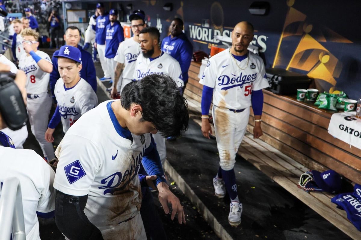 Teammates show concern as Dodgers dh Shohei Ohtani heads to the clubhouse after injuring his shoulder in Game two of the World Series at Dodger Stadium. (Robert Gauthier/Los Angeles Times/TNS)