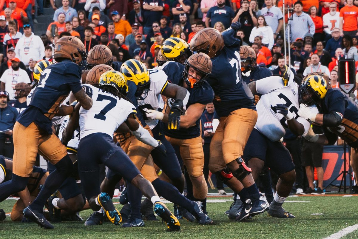 Illinois clashes with Michigan at Memorial Stadium during the third quarter of Saturday's game. The Illini defeated the Wolverienes 21-7.