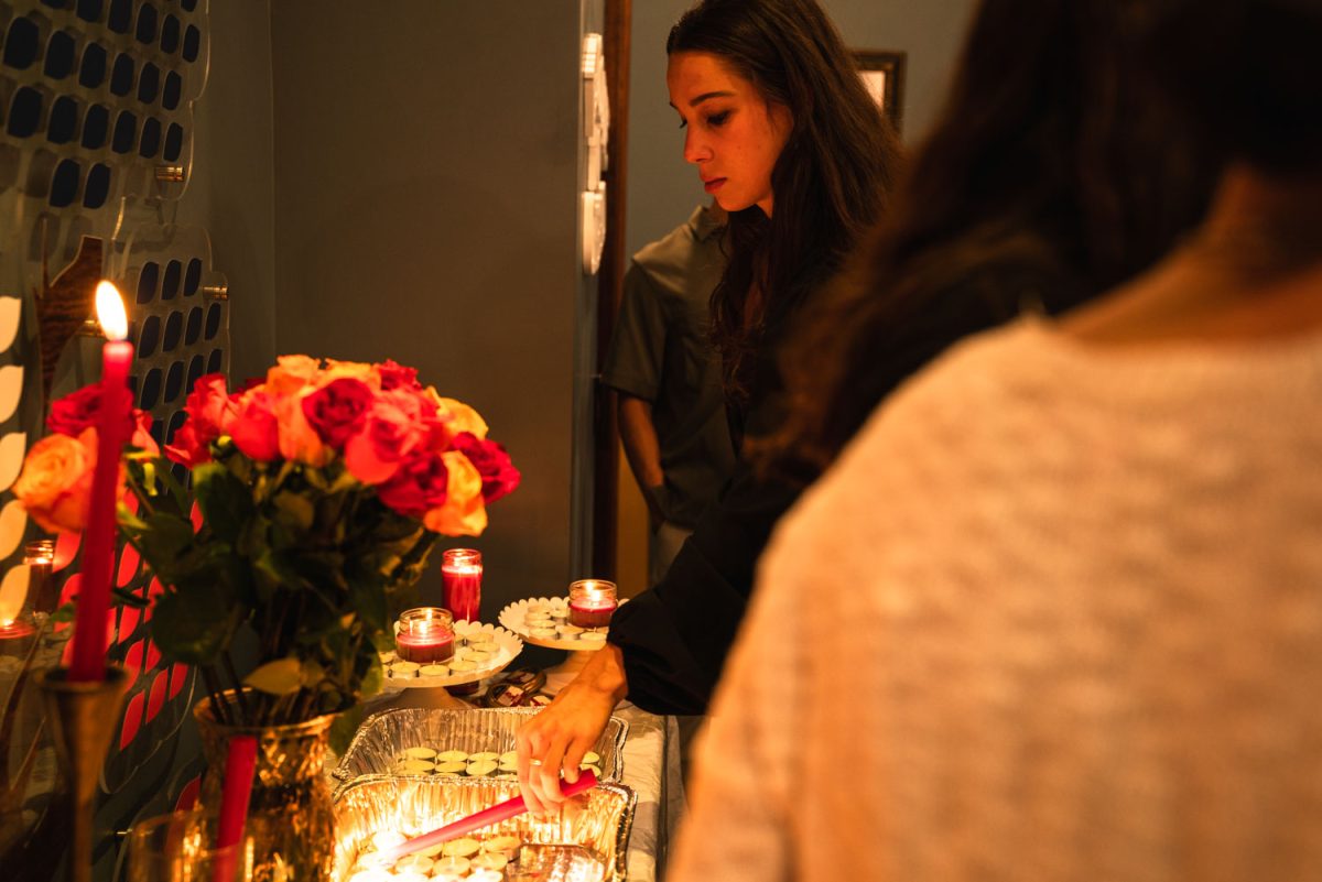 CU community members and students enter the Chabad Center for Jewish Life and light candles in tradition after being greeted by Rabi Dovid on Wednesday evening.