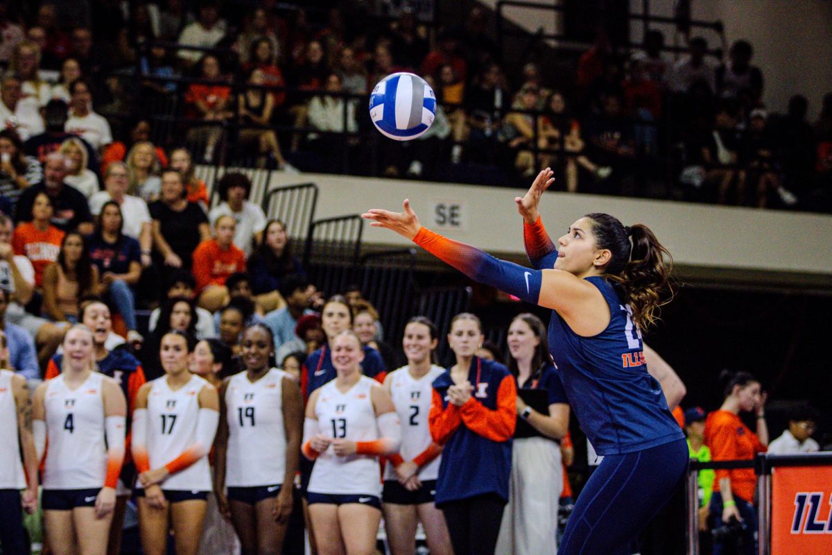 Graduate libero Christina Martinez Mundo up serves in the second set against the Nebraska Cornhuskers on Oct. 7 at Huff Hall.