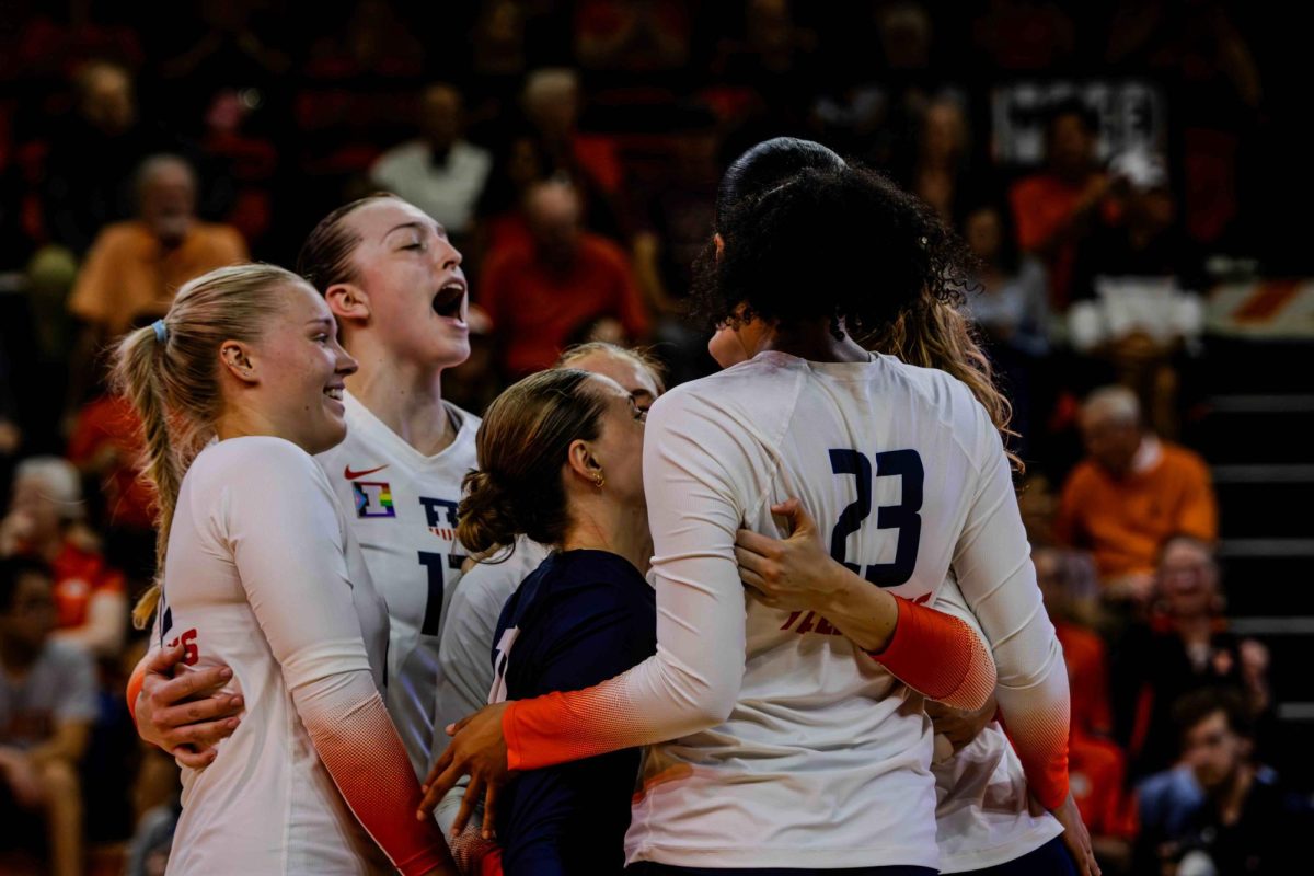 Illini Women's Volleyball team celebrate with a explosive roar as they take their first home win of the season agains the ISU Redbirds.