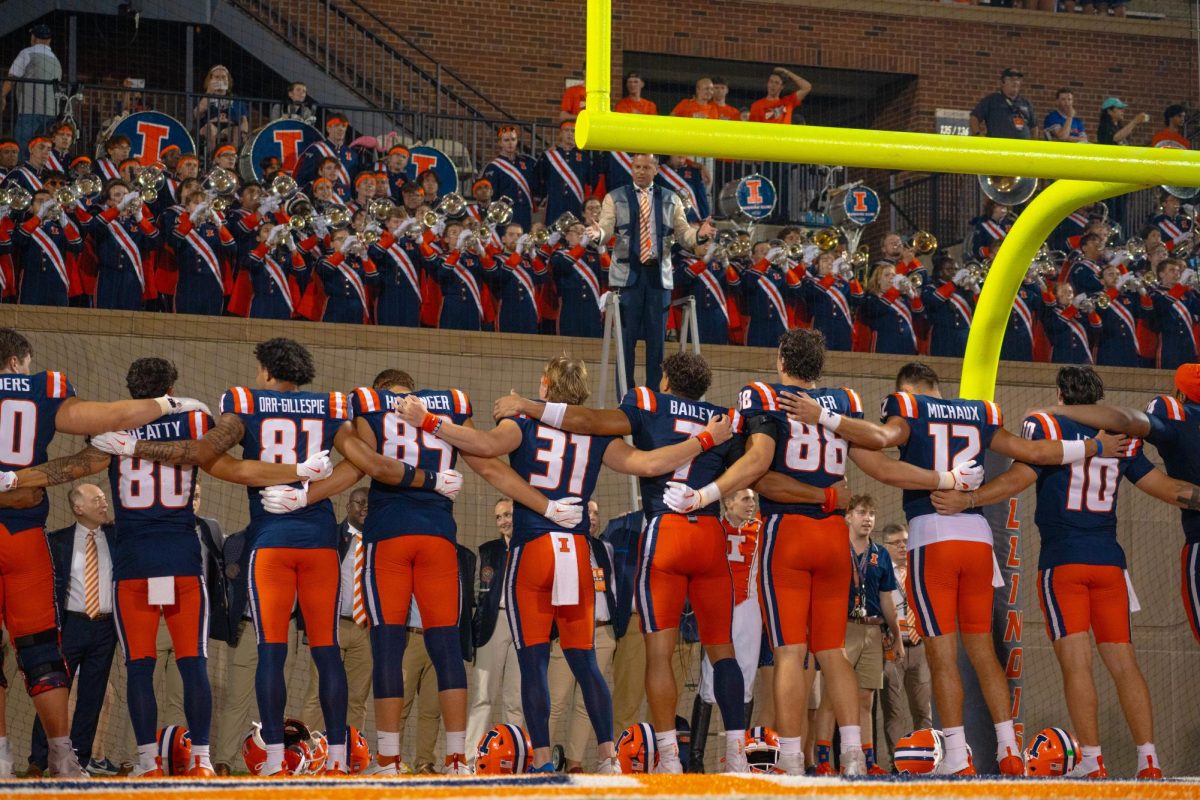 Illinois football sways with each other to sing "Hail to the Orange" after its victory over Eastern Illinois on Aug. 29.