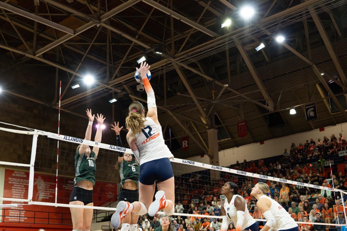 Graduate student outside hitter Raina Terry slams the volleyball over the net against Michigan State on Sept. 24, 2023. 