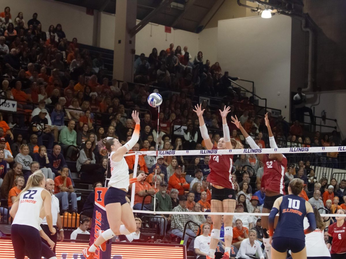 Raina Terry raises her hand up to hit the volleyball over the net against Wisconsin on Oct. 7, 2023.