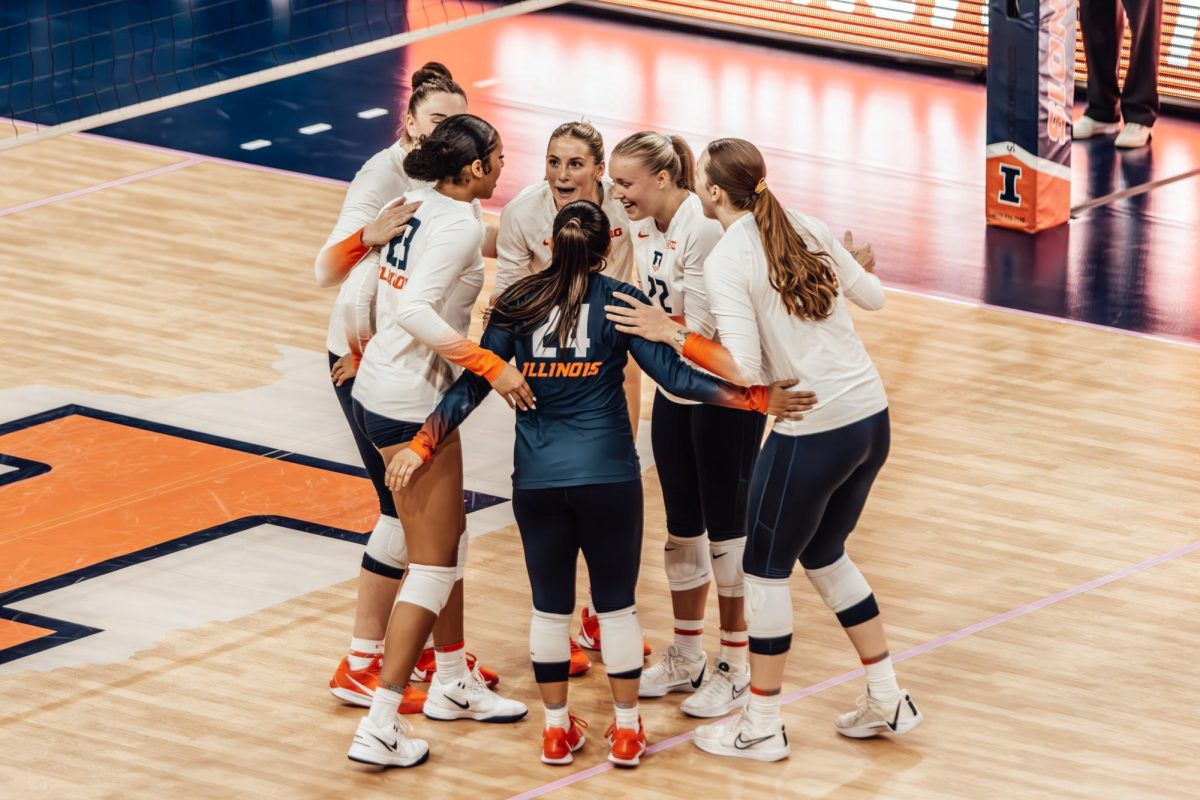 Illinois volleyball gathers into a huddle during its matchup against Maryland on Oct. 20.