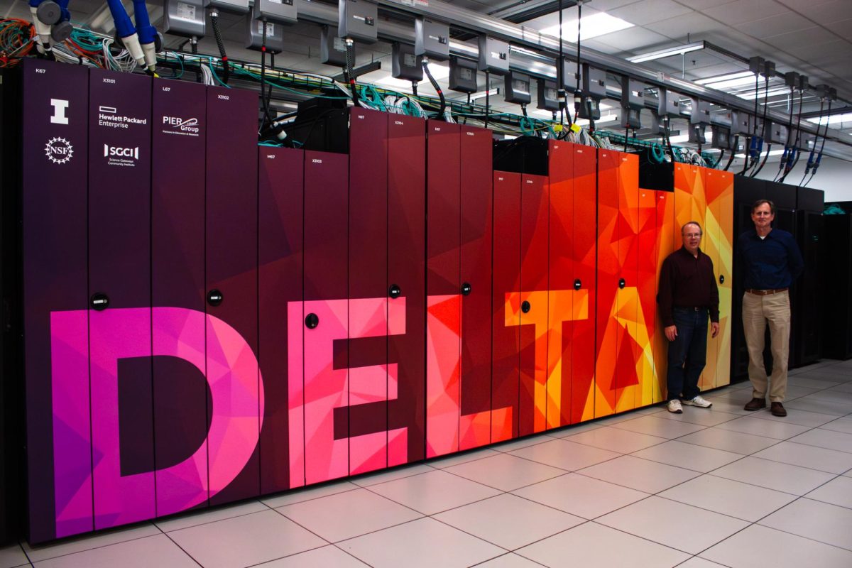 Gregory Bauer, co-principal investigator on Delta and Delta AI, with Brett Bode, Deputy Project Director of Delta and Delta AI, in front of the Delta computing resource at the National Petascale Computing Facility on Friday.