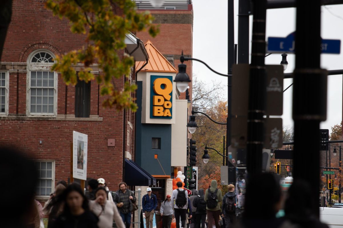 Students walk by the newly opened QDOBA Mexican Eats located at 711 S. Wright St. on Monday.