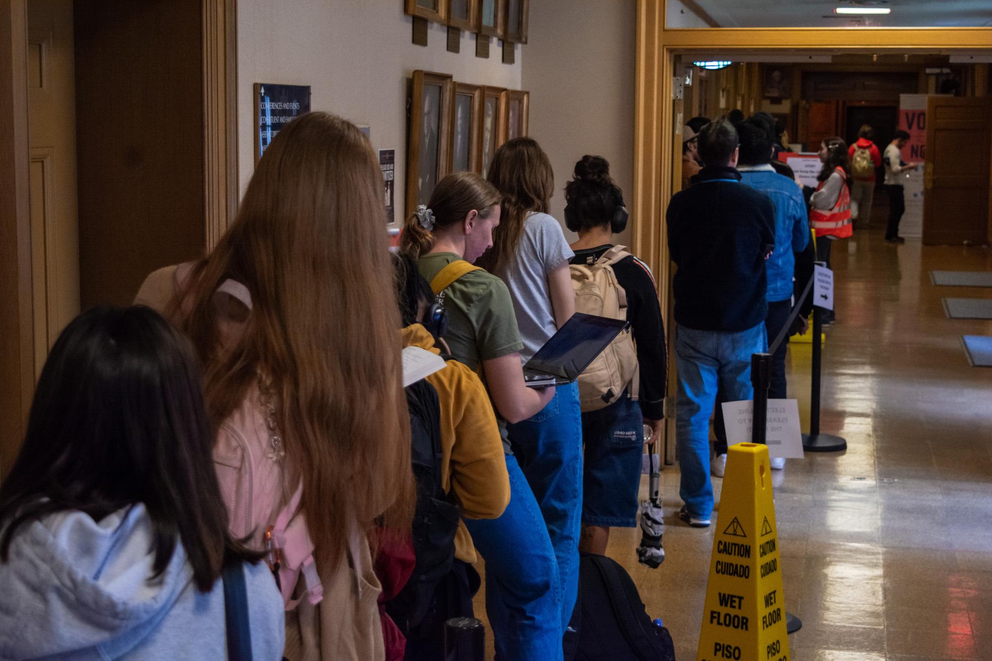 Voters wait in line at the Illini Union at 11:00 a.m. on Nov. 5. Lines trailed around the perimeter of the Union, zig-zagging through the ballroom.