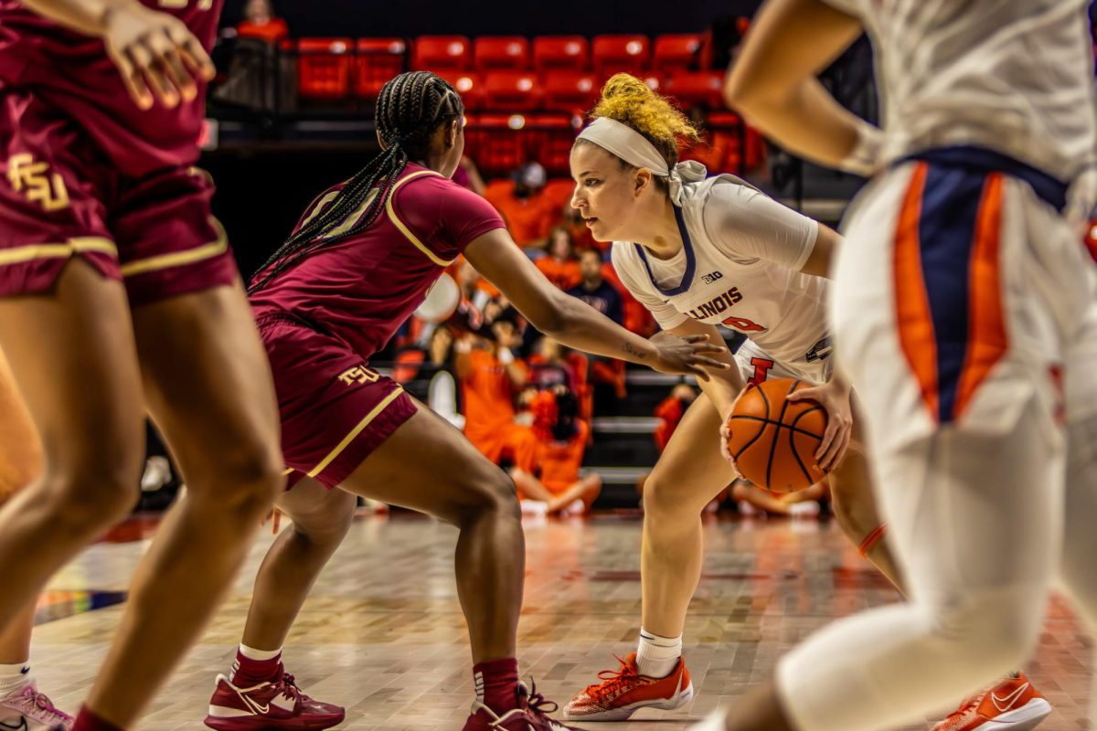 Sophomore guard Gretchen Dolan attempts to drive the ball past her Florida State opponent on Nov. 7 at the State Farm Center in Champaign.