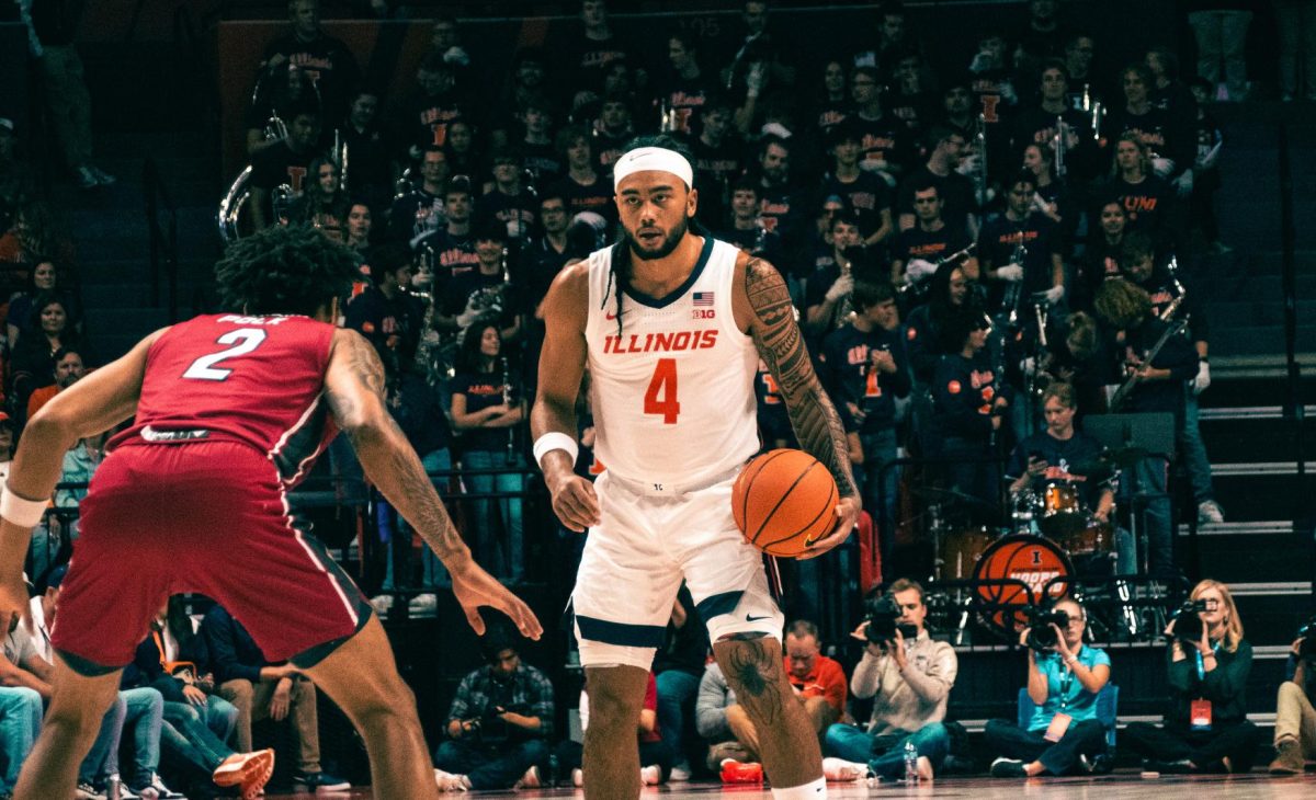 Junior guard Kylan Boswell dribbles the ball against SIUE on Nov. 8 at the State Farm Center.