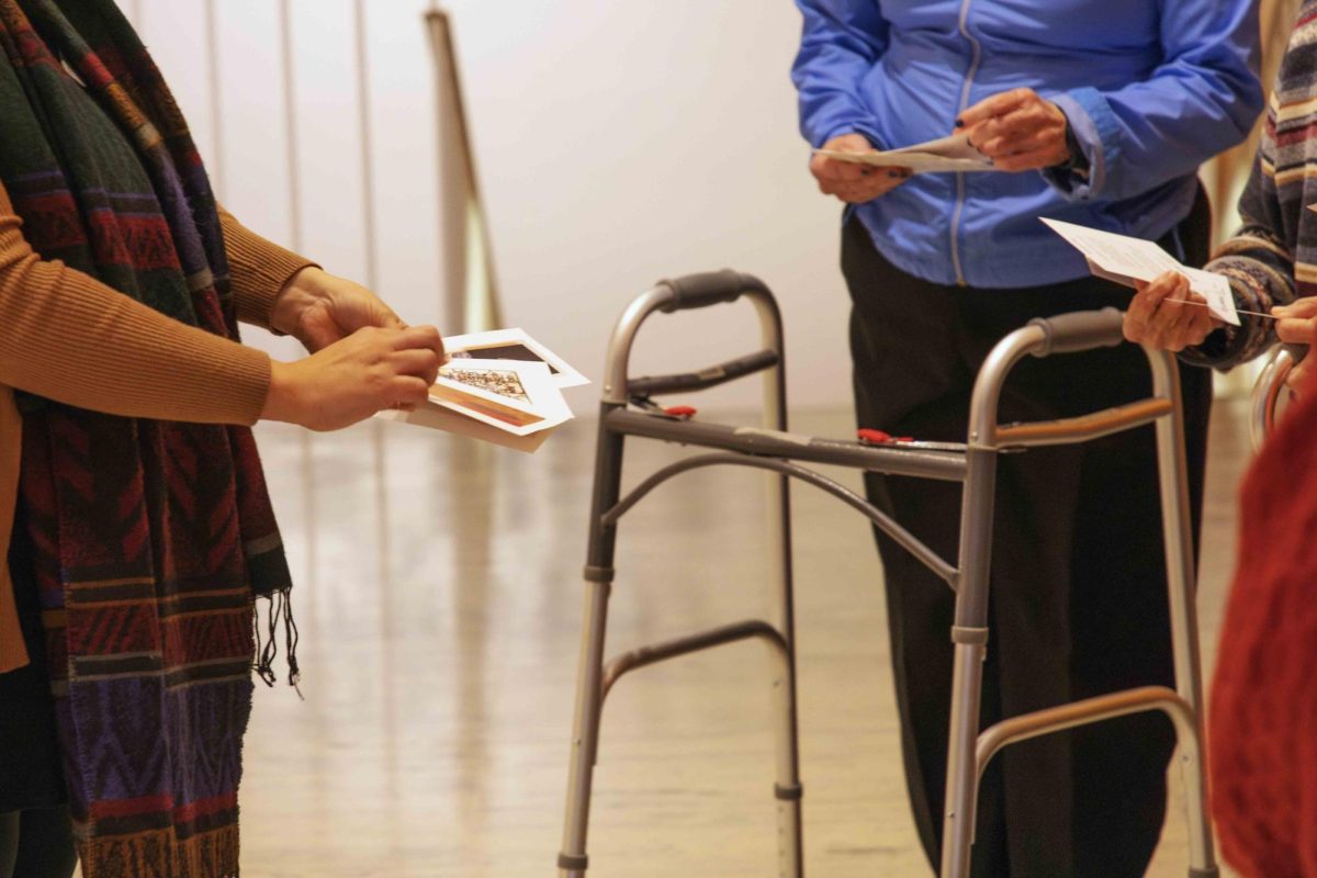 Visitors of the Creative Aging event at the Krannert Art Museum on Nov. 13 after being instructed to chose four cards, all containing artwork in KAM, explaining why they gravitated towards certain works.