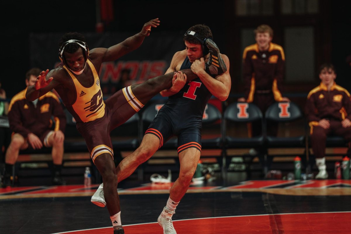 Redshirt junior 141-pounder Danny Pucino holds his opponents leg tightly as he attempts a takedown at State Farm Center on Nov. 19.