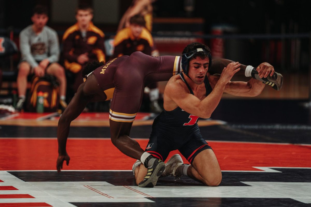 Redshirt junior attempting a takedown in a match against Central Michigan on Nov. 19, 2023.