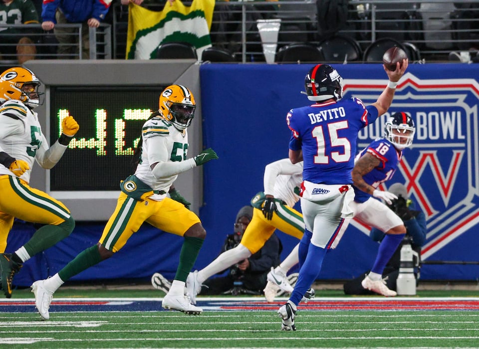 Giants quarterback Tommy DeVito (15) rolls to his right and finds wide receiver Isaiah Hodgins (18) in the back of the end zone for a touchdown during his team's shocking upset of the Green Bay Packers last season.