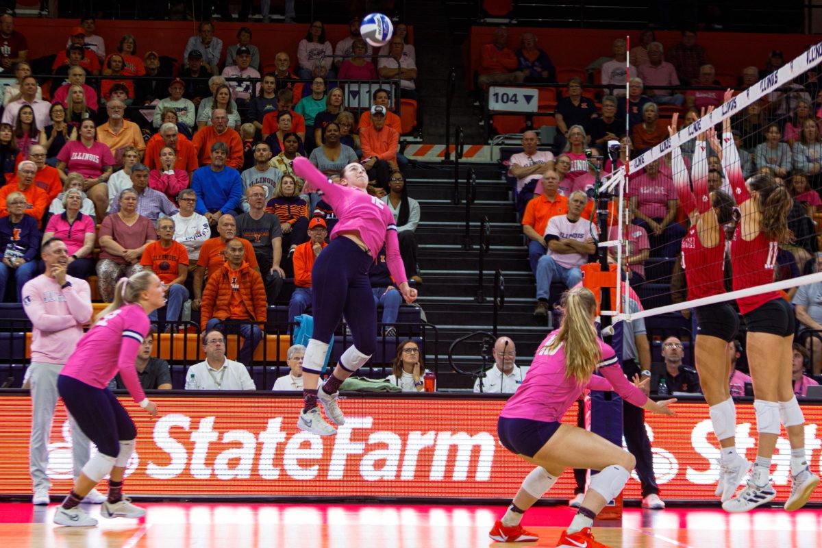 Graduate student Raina Terry rears back for an emphatic spike against Indiana on Oct. 16.