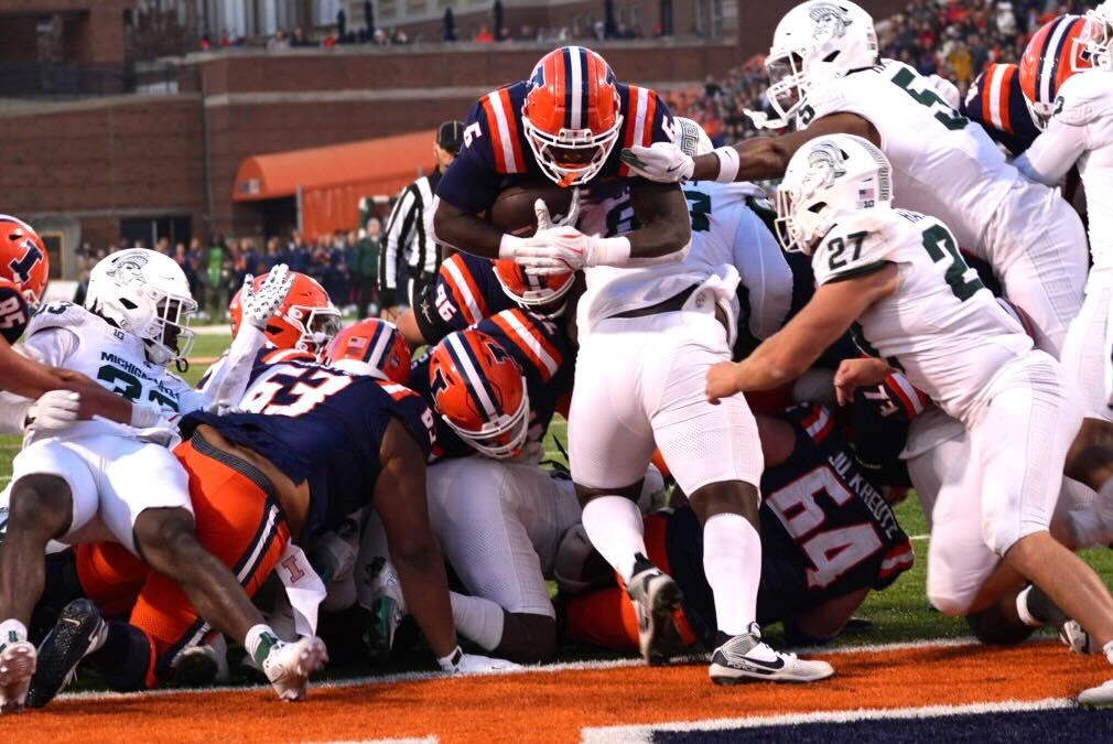 Junior running back Josh McCray leaps over a sea of defenders into the end zone to score a touchdown against Michigan State. 