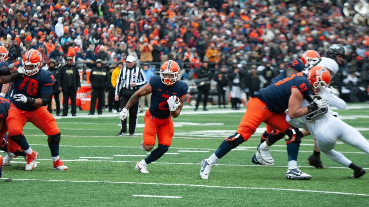 Running back Chase Brown rushes the football through an open gap against Purdue on Nov. 12, 2022. 