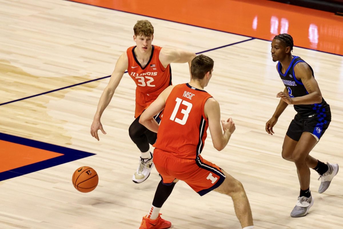 Freshman guard Kasparas Jakučionis dribbles around a screen set by sophomore center Tomislav Ivisic on Nov. 3 against Eastern Illinois.