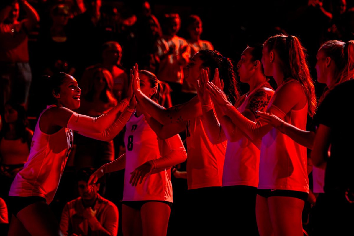 Freshman outside hitter Laynie Smith high fives her teammates before the matchup against Nebraska on Oct. 3, 2024.